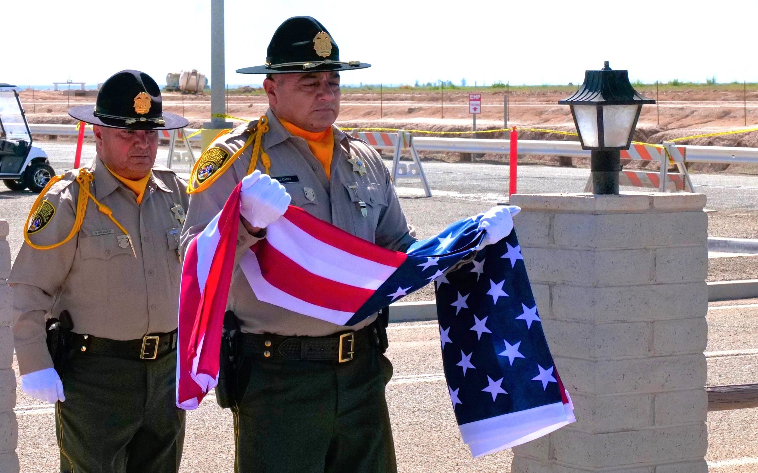 Officers carry the flag during a National Crime Victims' Rights Week event at Calipatria State Prison.