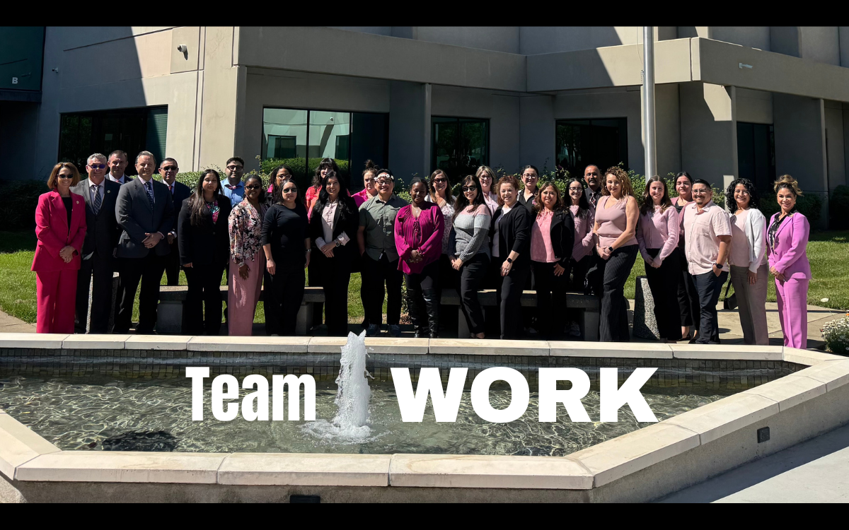 CARU group photo during staff training with the words "team work" overlaying the image.