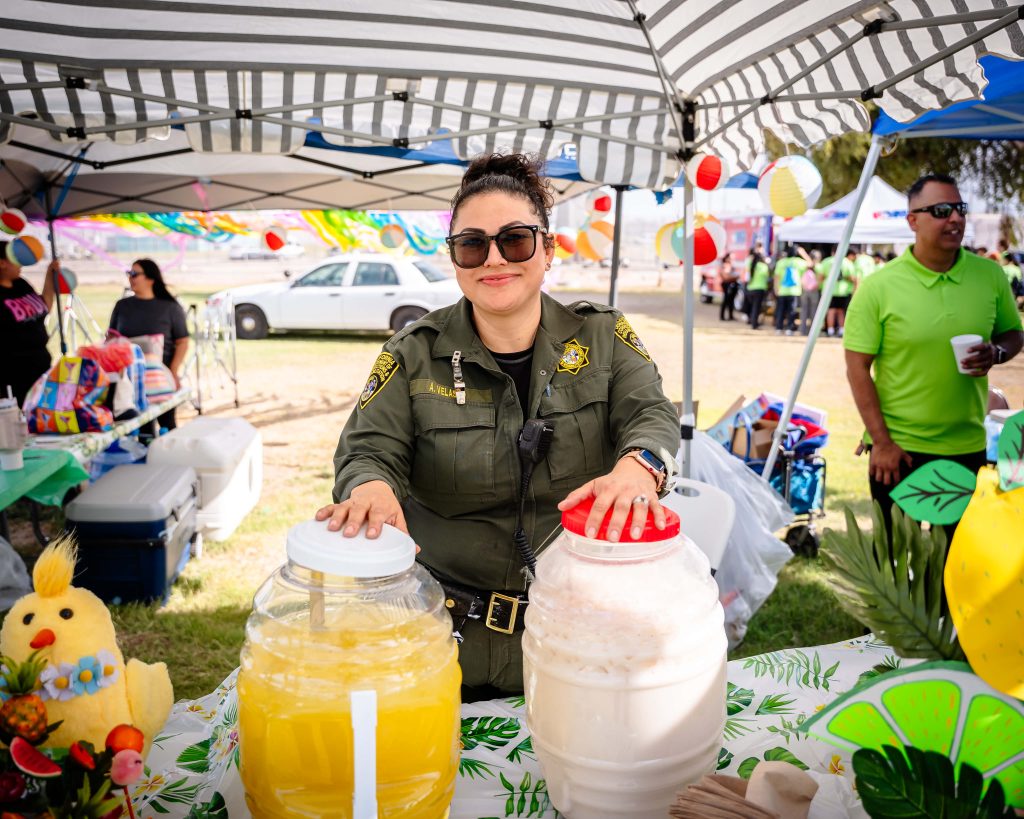 Officer Velasco with beverages at the Centinel State Prison event. 