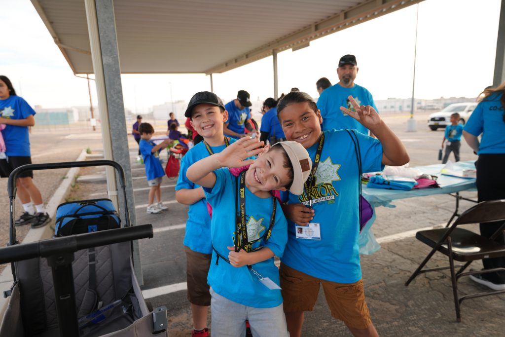 Kids in blue pose for the camera at Centinela State Prison's academy.