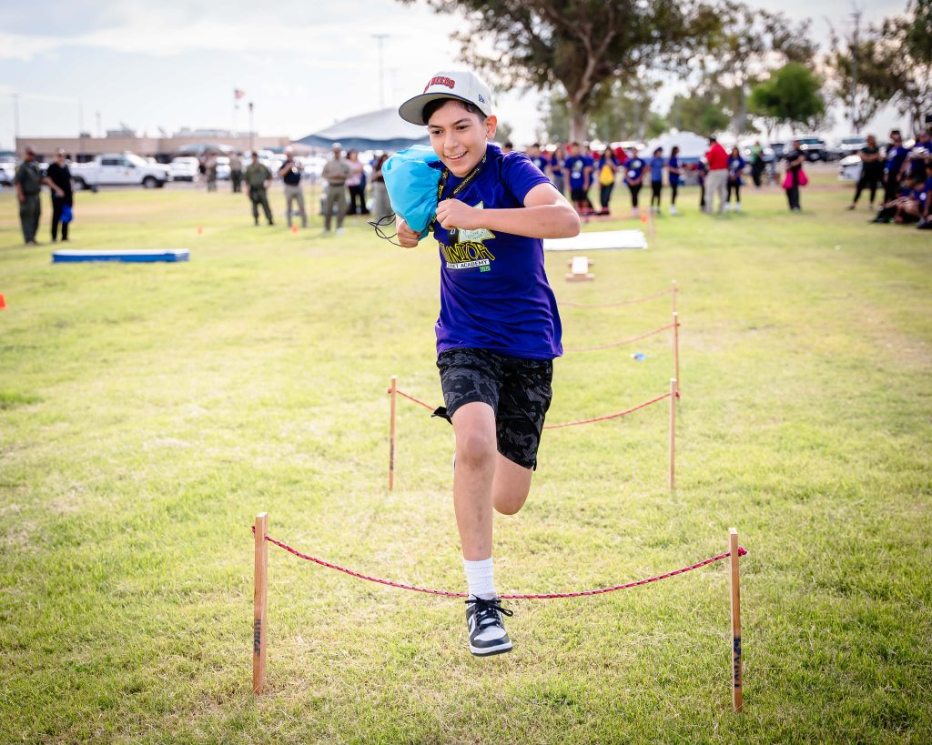 Kids running an obstacle course at Centinela State Prison.