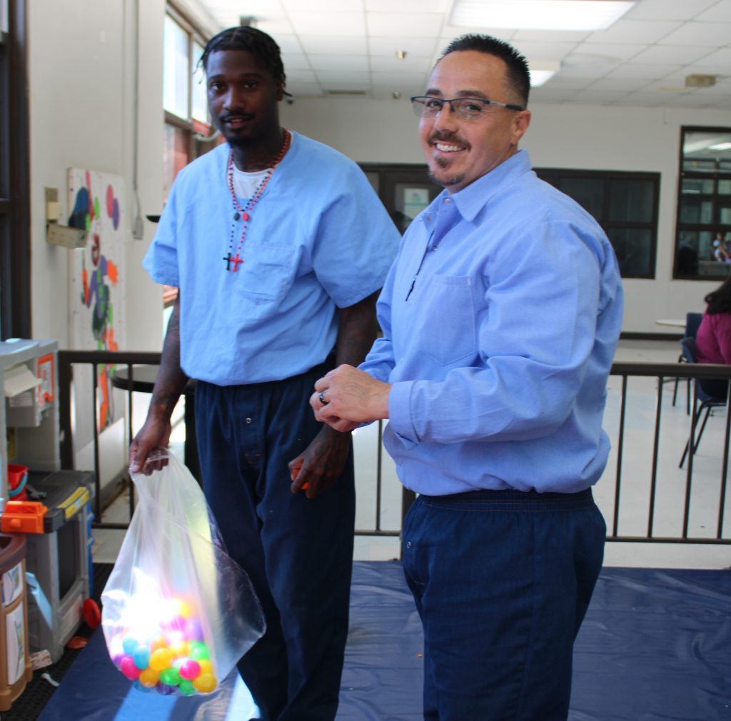 Centinela State Prison incarcerated persons hide eggs for their children during Easter visiting.