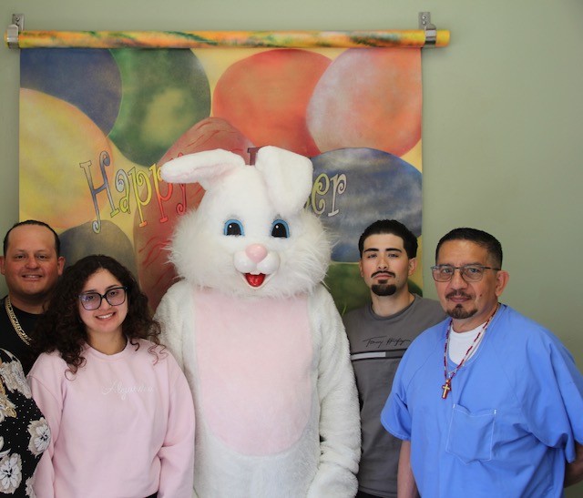 Family poses for a photo with the Easter bunny at CHCF in Stockton during Easter visiting.