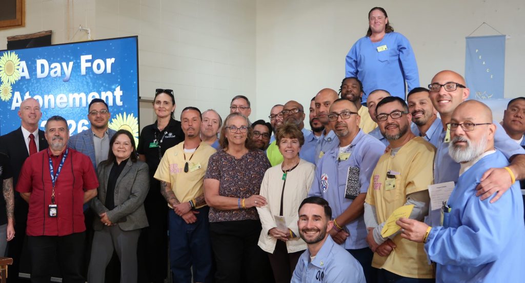 Group photo of incarcerated people, staff, guests at Day for Atonement at San Luis Obispo's California Men's Colony.