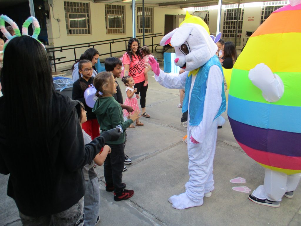 Easter bunny visits with families at CMF visiting.