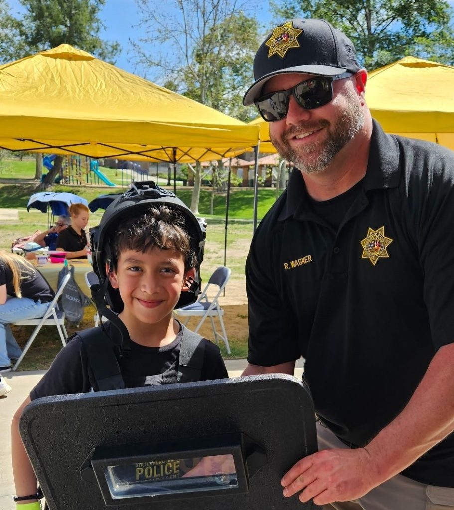 A parole agent interacts with a child at an Easter event.
