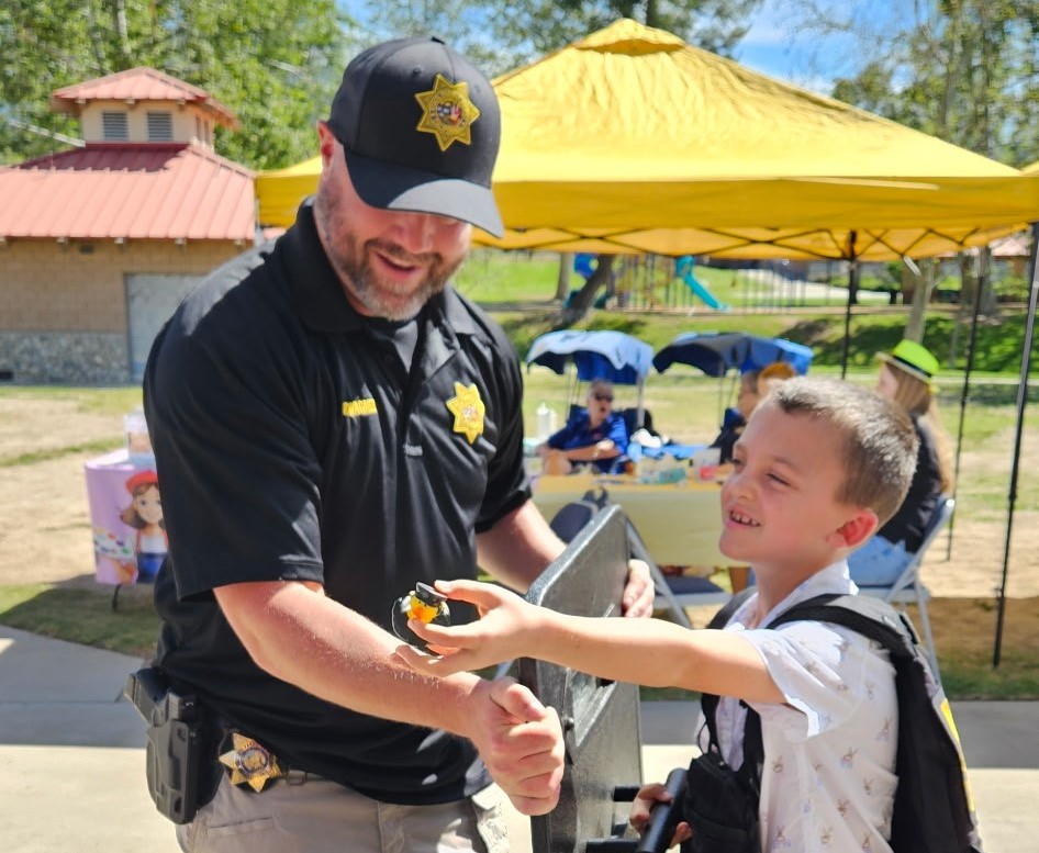 A parole agent interacts with a child during the Easter Extravaganza event. 