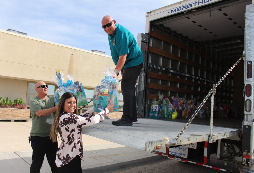 Ironwood State Prison staff load a truck of Easter baskets for a school.