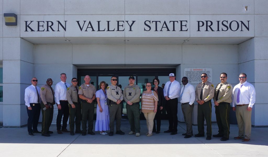 Two officers with hospital staff and KVSP executives.