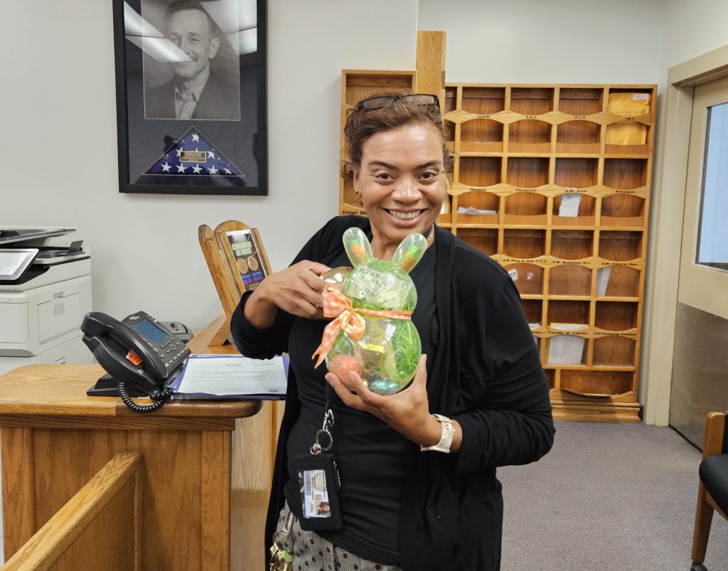 Staff member at LAC with a prize after finding a golden egg. 