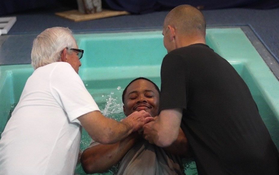 An incarcerated youth from Pine Grove Youth Conservation Camp receives baptism at a local church.