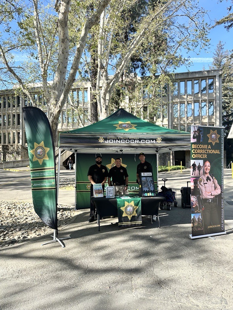 CDCR recruitment staff stand at booth on college campus