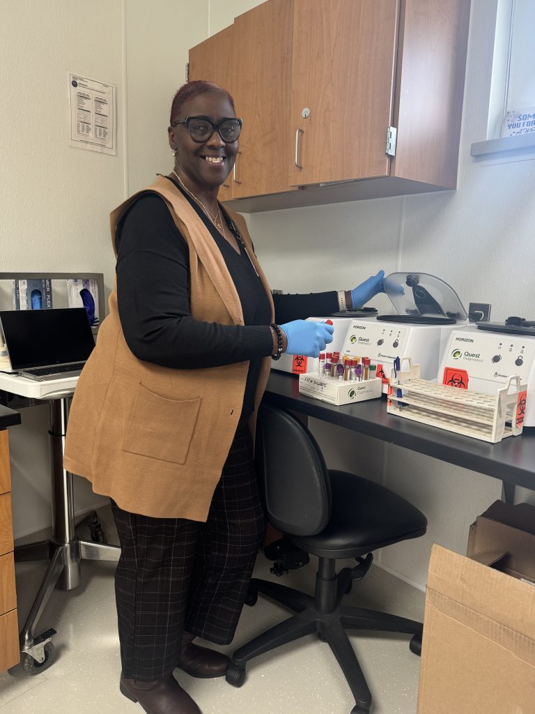 Tammie Howze stands near medical lab equipment