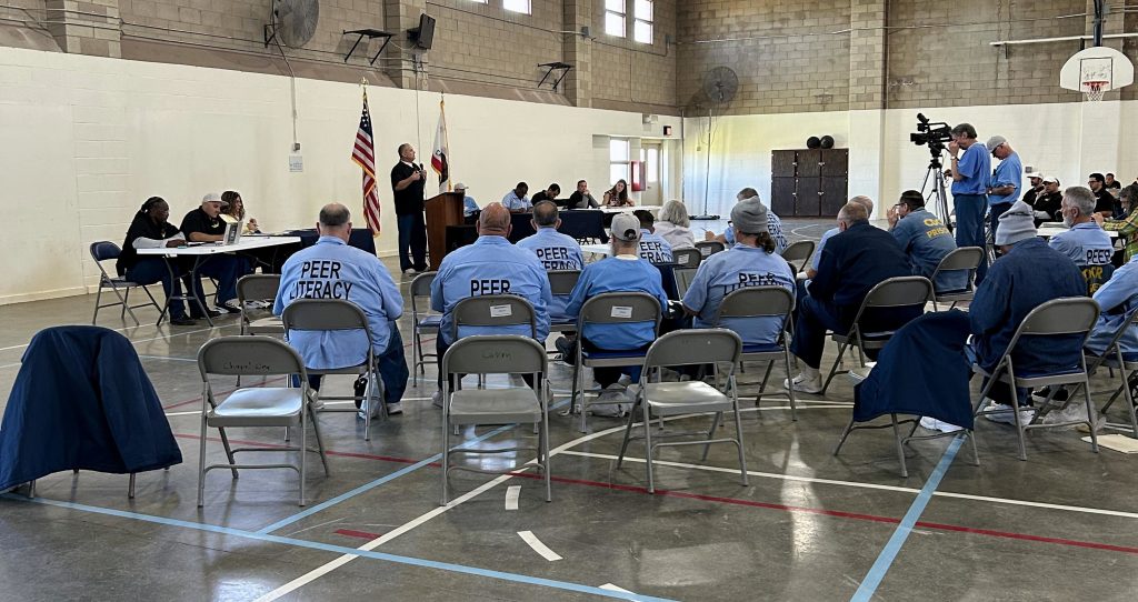 Large room with VSAS staff and incarcerated participating in debate
