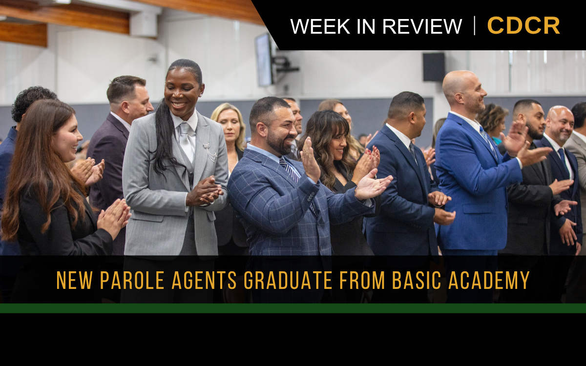 Parole agent graduates standing together smiling and applauding