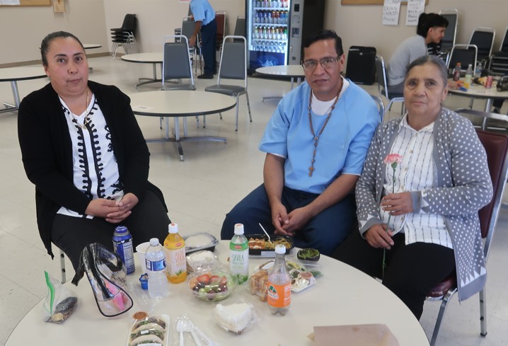 Three people at Avenal State Prison during Mother's Day visiting.