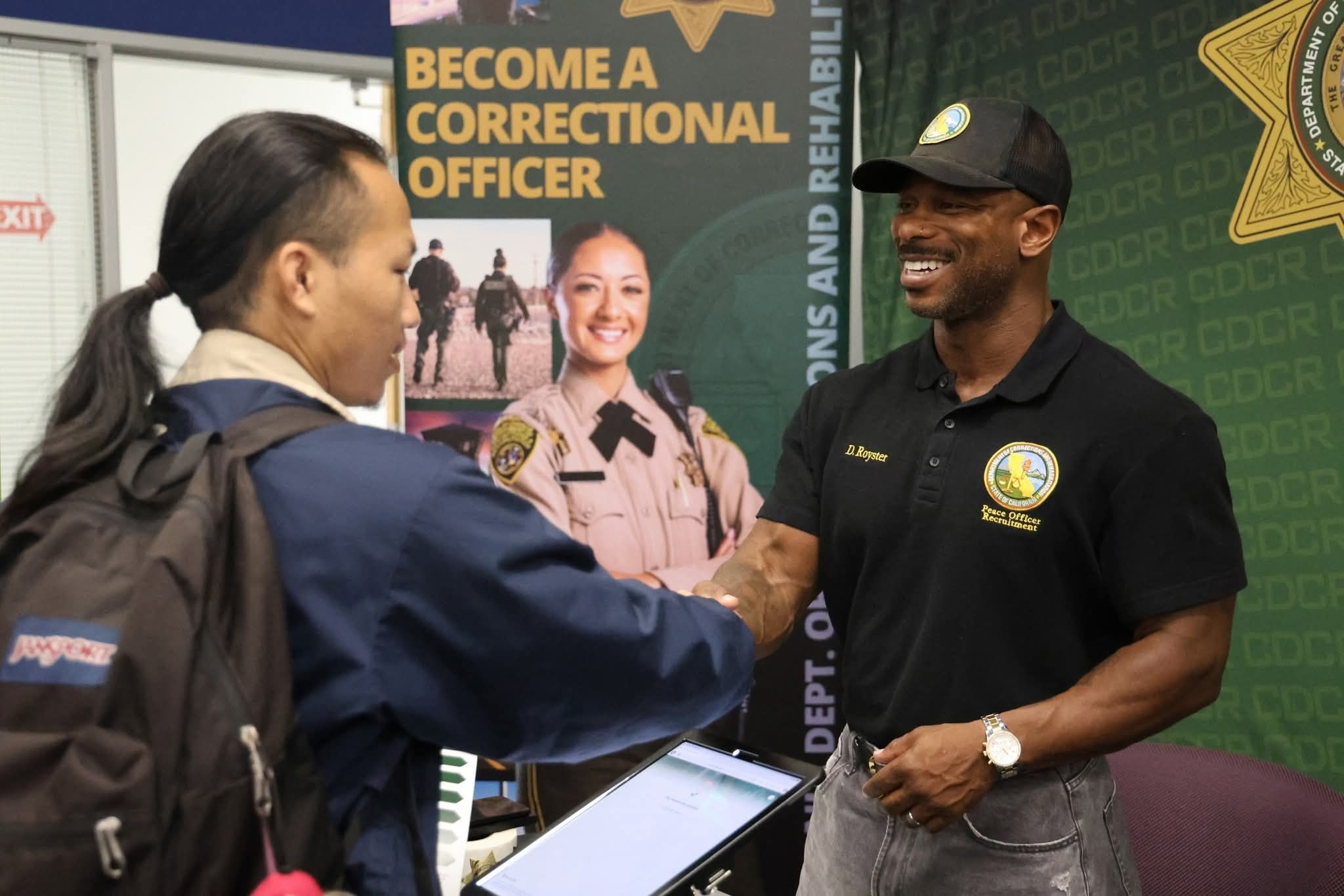 Recruiter and student shaking hands at Athletes to Officers career fair