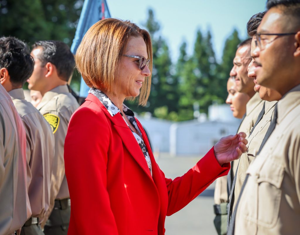 Gena Jones speaks with the cadets before graduation.