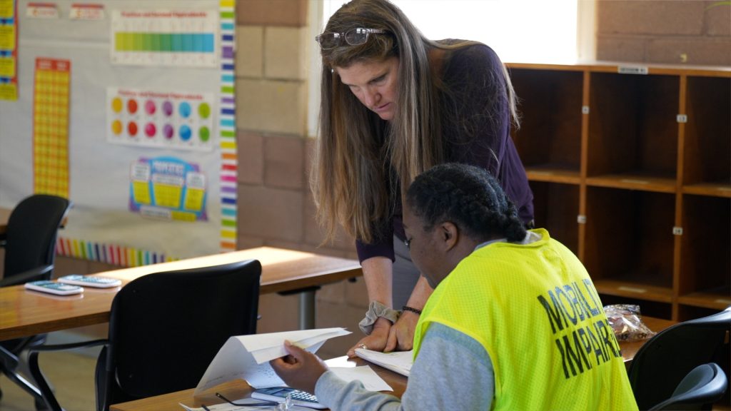 CCWF teacher offers help to a student.