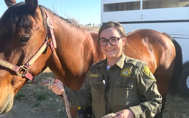 A staff member enjoys a break with a horse during a CCWF mental health awareness event.