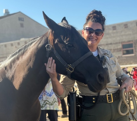A horse with a correctional officer at CCWF in Chowchilla.
