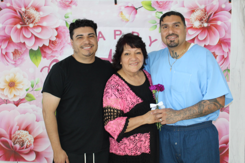 An incarcerated person with a flower given to his visiting family members at Centinela State Prison on Mother's Day.