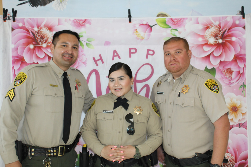 Centinela State Prison visiting staff organized a special Mother's Day event for families visiting their incarcerated loved ones. Image shows a sergeant and two correctional officers.