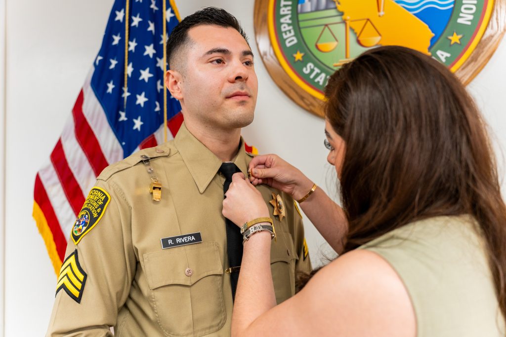 New sergeant R. Rivera being pinned by a family member.