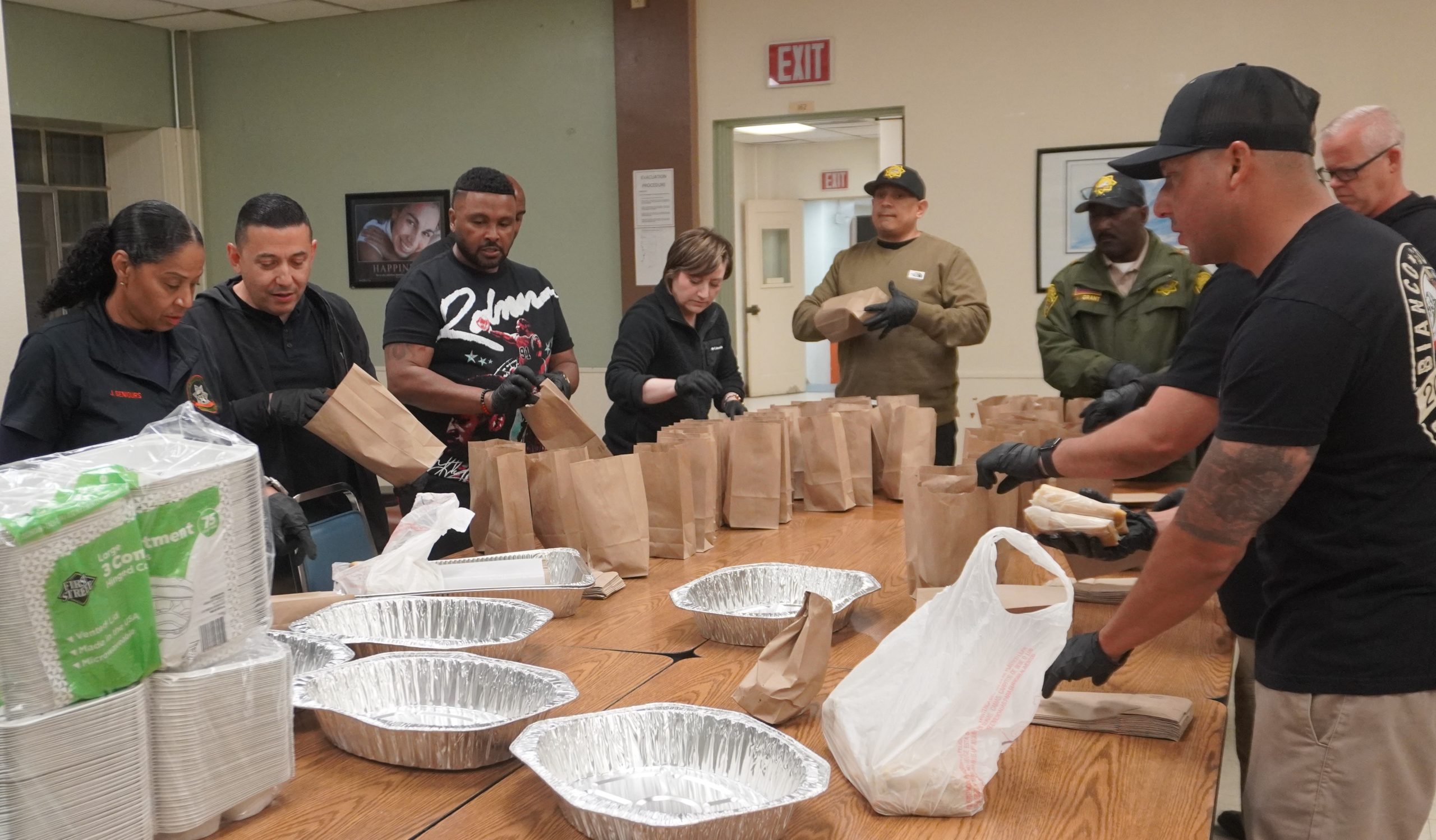 CIM managers and executives pack food for first watch. 