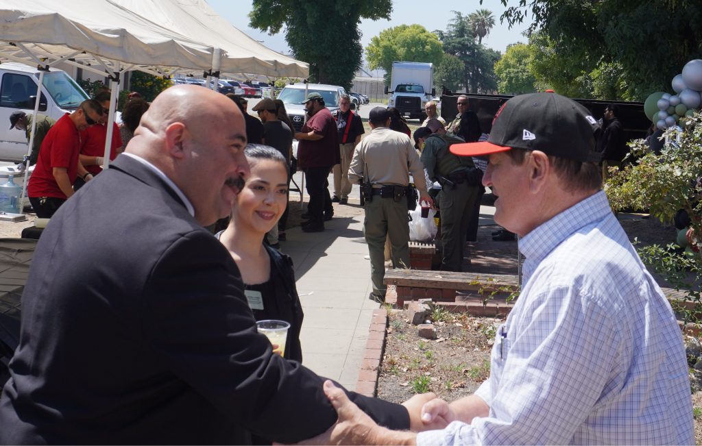 Warden shakes hands with staff at CIM.