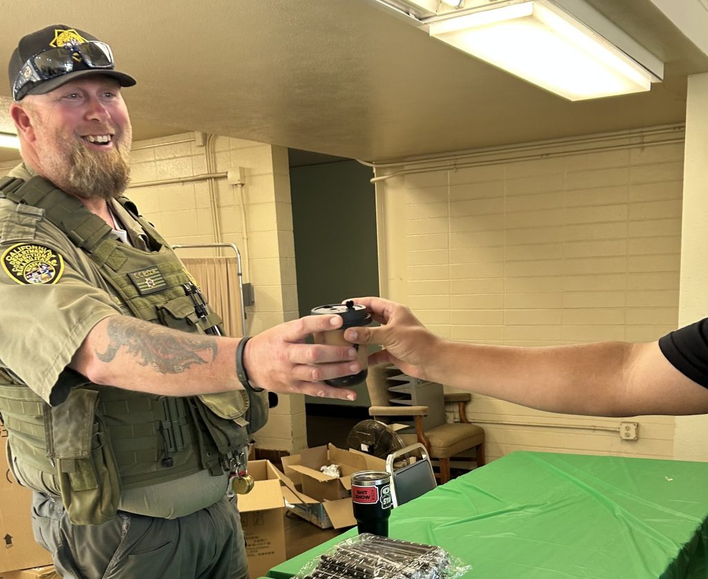 An officer receives a complimentary cup of coffee during CMC's Fill Your Cup Day.