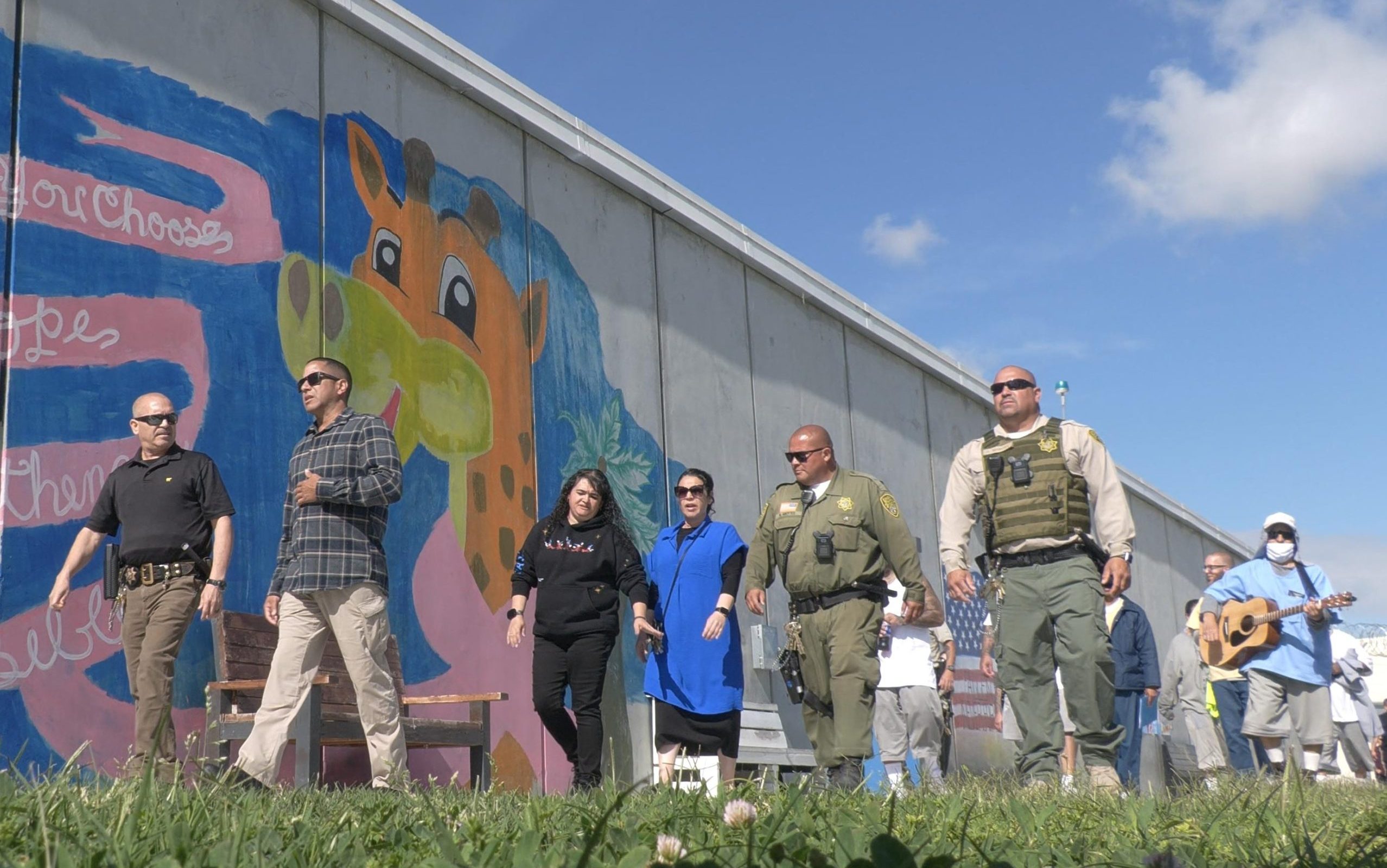 California State Prison, Corcoran, hosted their third annual Cancer Walk with staff and the incarcerated population, shown walking around a prison yard togther.