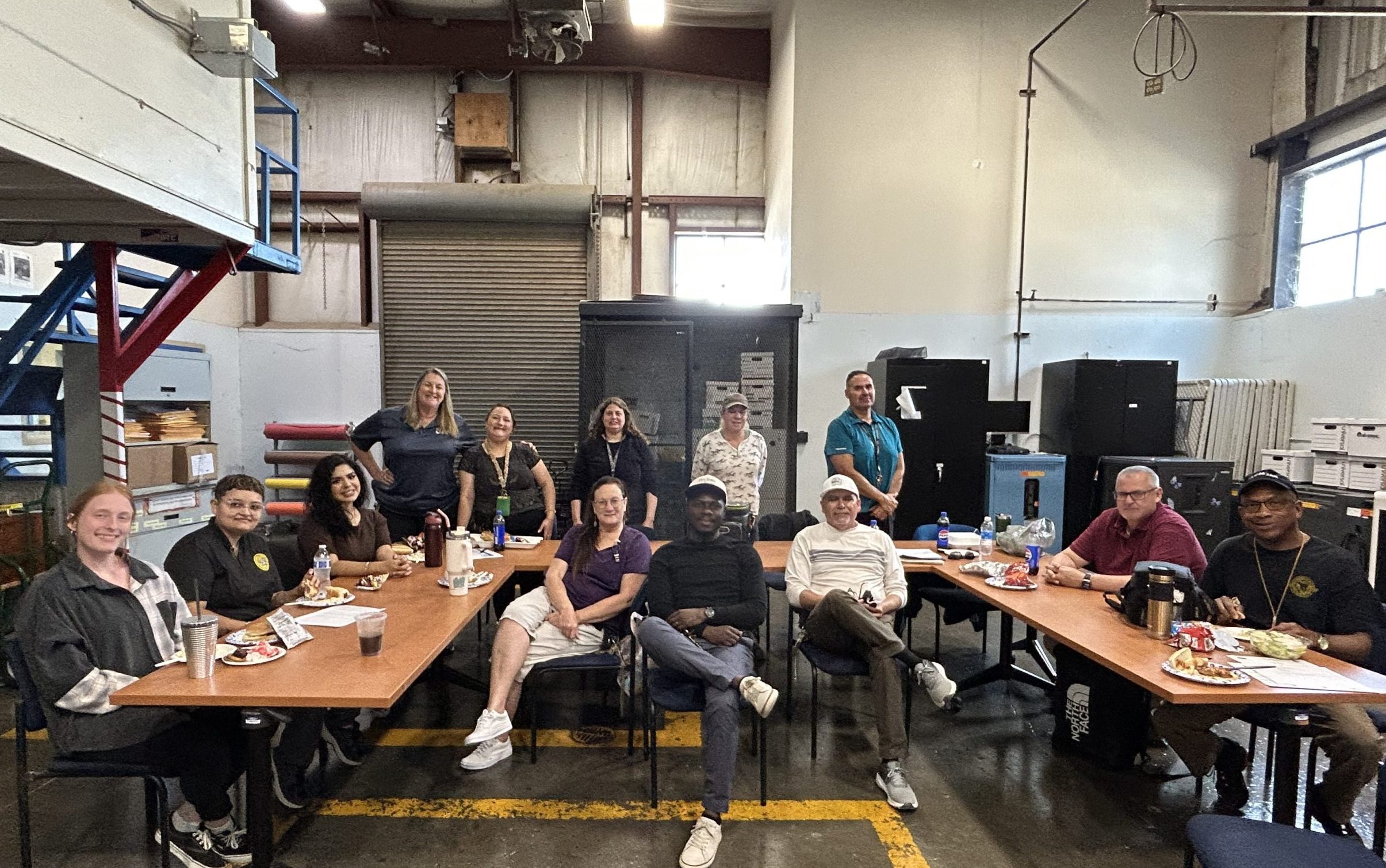 Group photo of employees enjoying food during a staff appreciation event at CSP-Corcoran.
