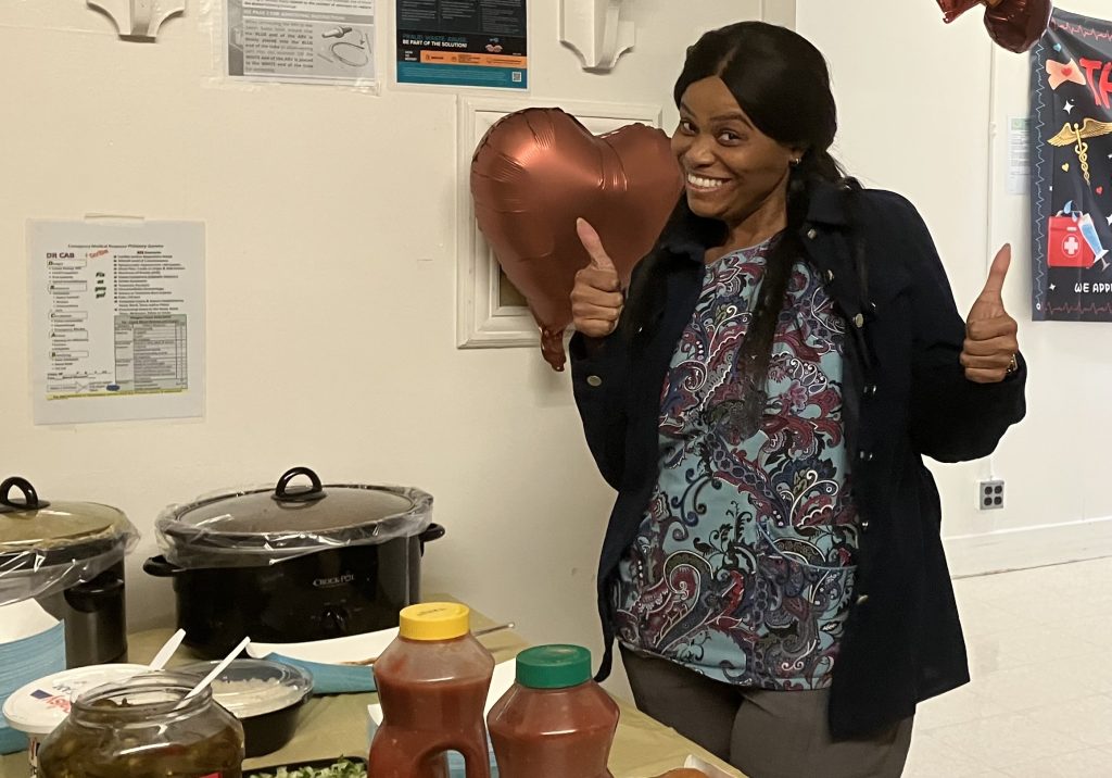 A staff member gives a thumbs-up at CRC-Norco's Nurses Week celebration.
