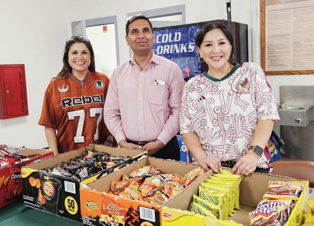 Group of people behind a table handing out snacks at Centinela State Prison.