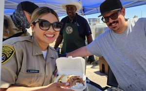 Two people smiling at Centinela State Prison's staff appreciation event.