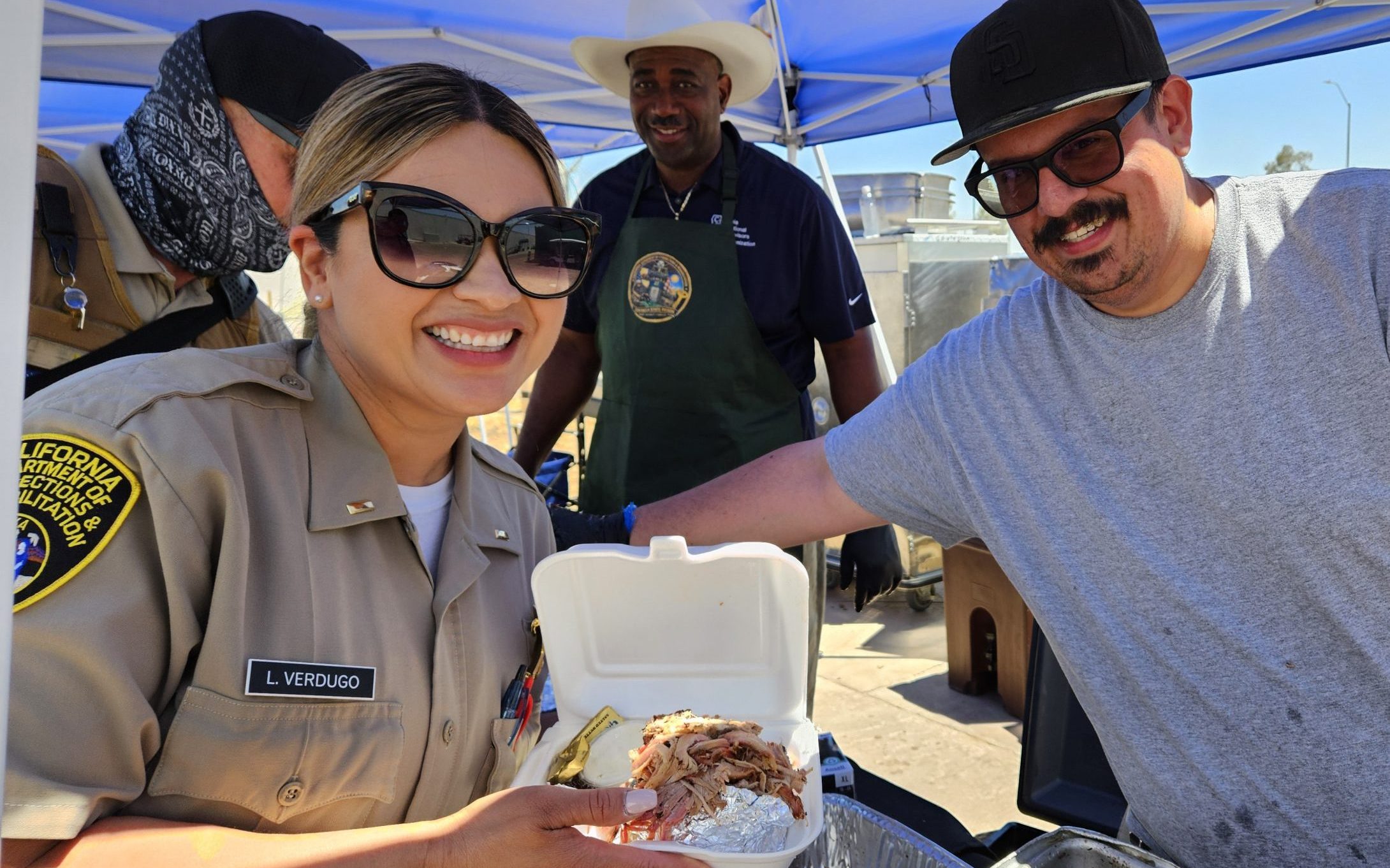 Two people smiling at Centinela State Prison's staff appreciation event.