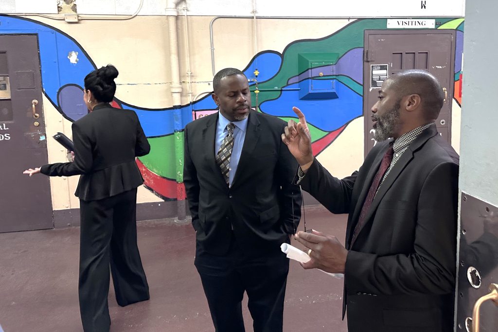 Undersecretary Jason Johnson tours CTF-Soledad while other people explain the area of the prison.