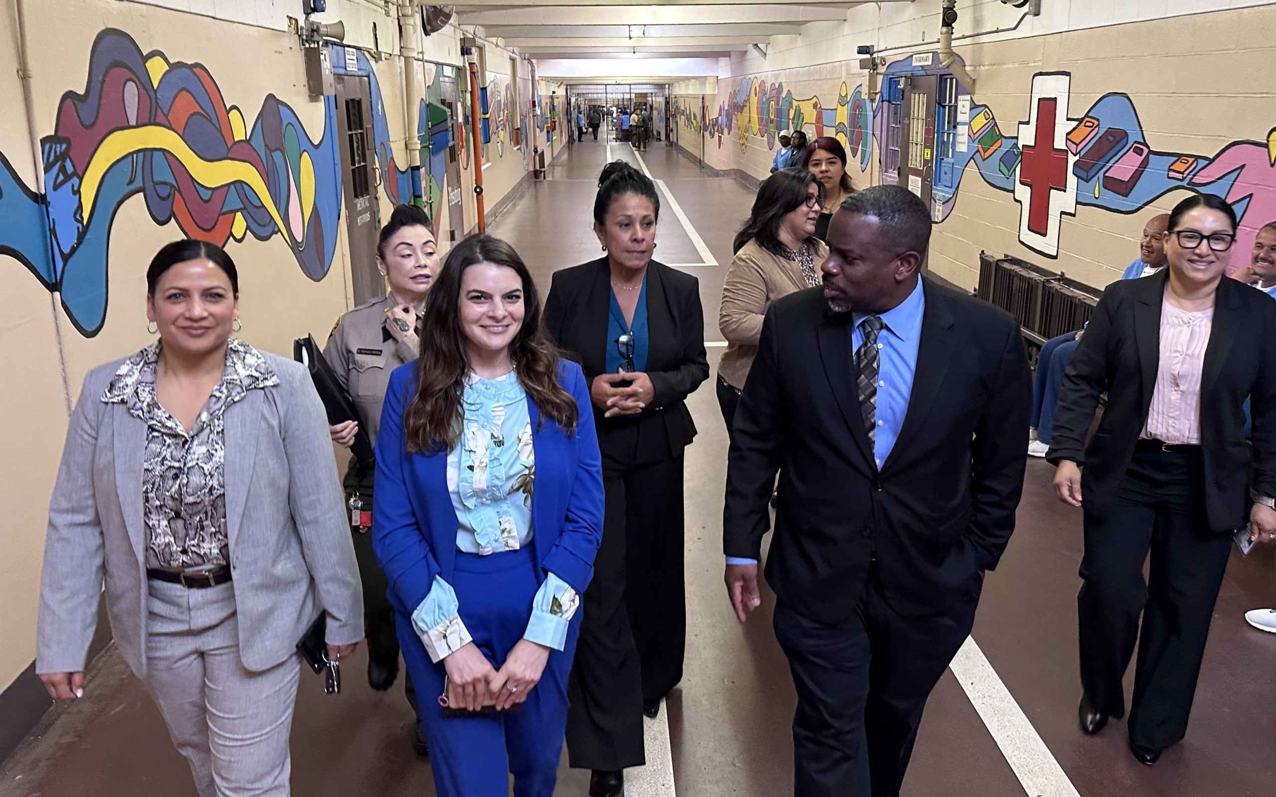 CTF-Soledad Undersecretary Johnson tours CTF-Soledad. He's shown walking down a hallway with other CDCR and prison staff.