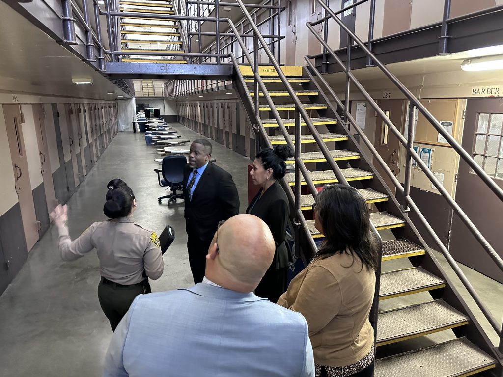 Staff tour a housing unit at CTF-Soledad.