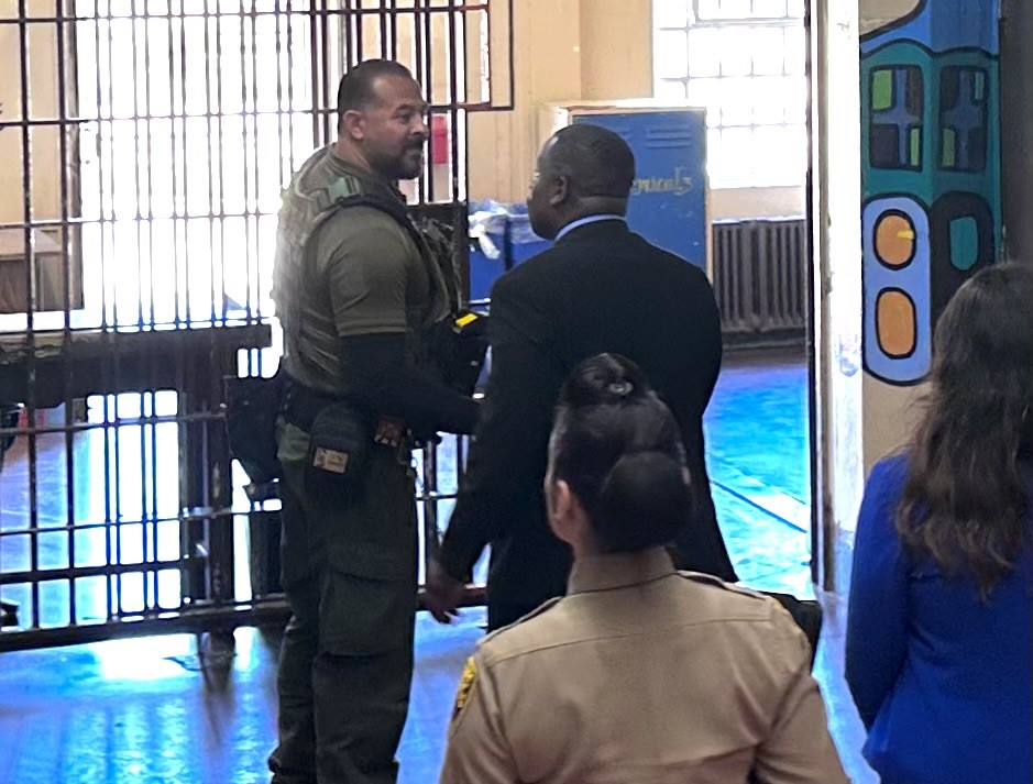 The Undersecretary shakes hands with a staff member.
