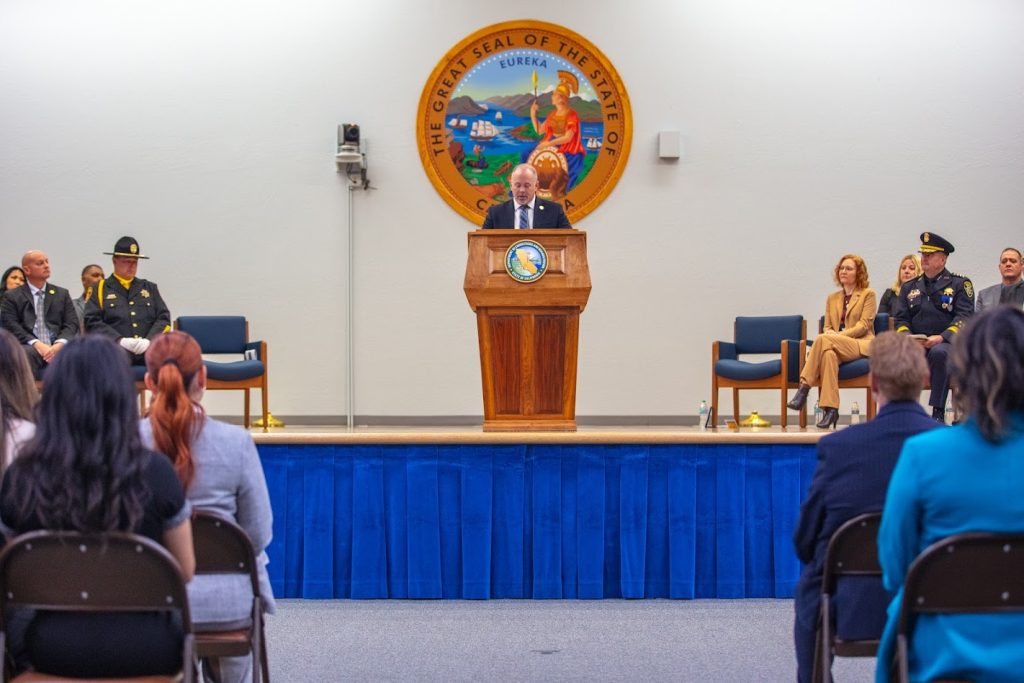 The parole director speaks to the gathering at the academy.