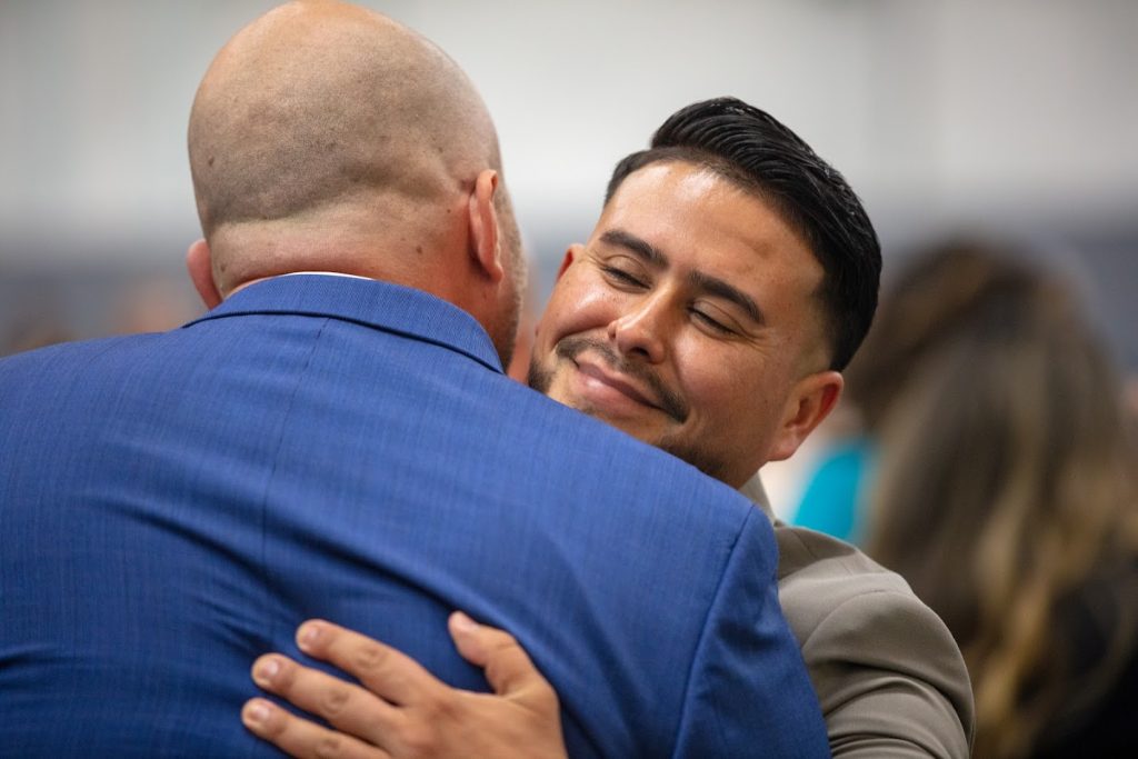 Hugs and smiles after the parole agent graduation ceremony.