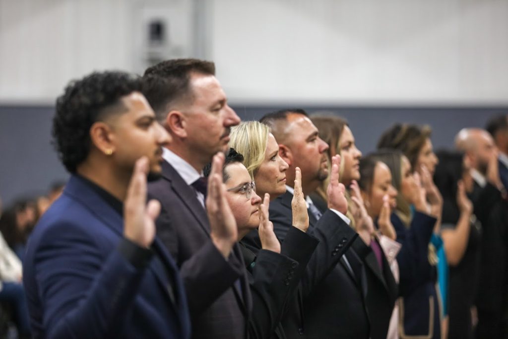 Some of the 38 new CDCR parole agents take the oath, being sworn in after graduating. 
