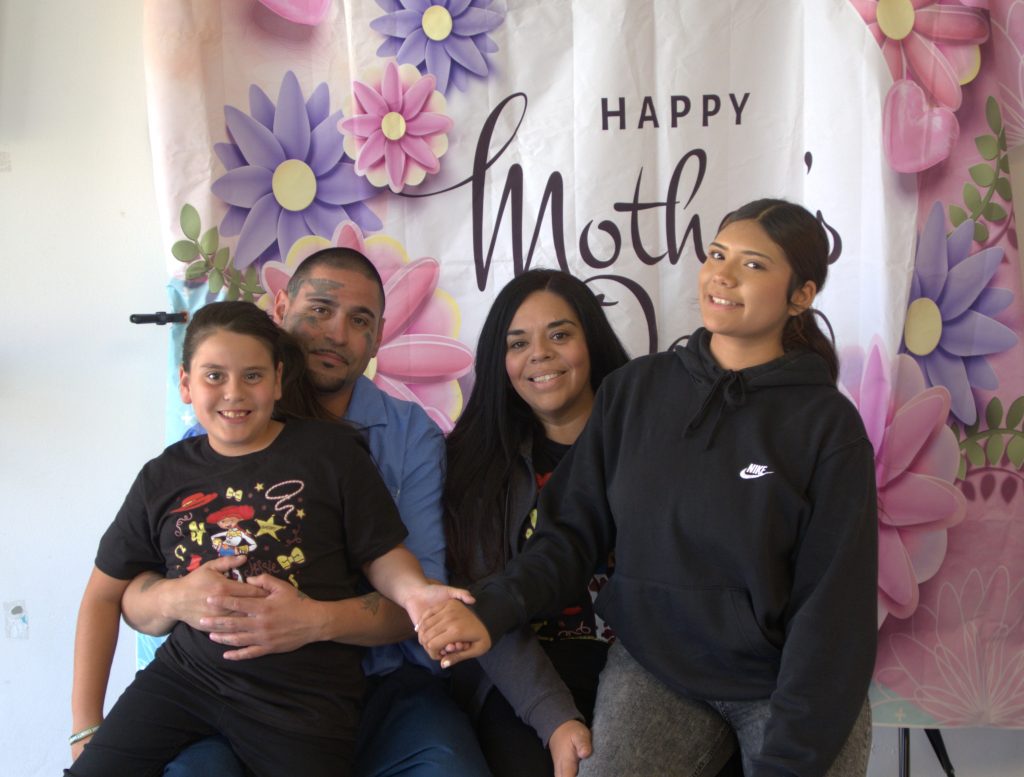 A family poses for a photo with their incarcerated loved one on Mother's Day at High Desert State Prison in Susanville, California.