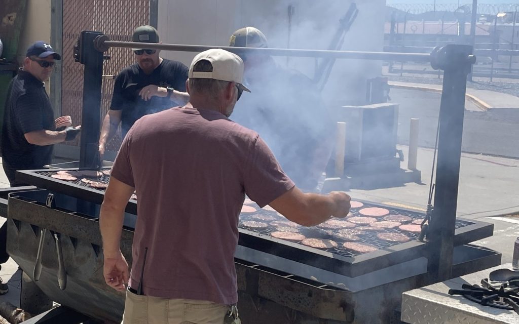 A staff member works the grill at High Desert State Prison in Susanville, California.