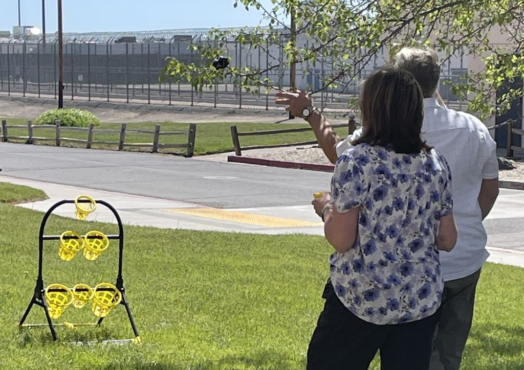 A man tries his luck at a beanbag tossing game during Staff Appreciation Day, May 6, 2026, at High Desert State Prison in Susanville, California.