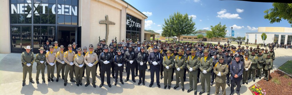 Large group photo of honor guard members outside building for TCSO Randy Hoppert funeral