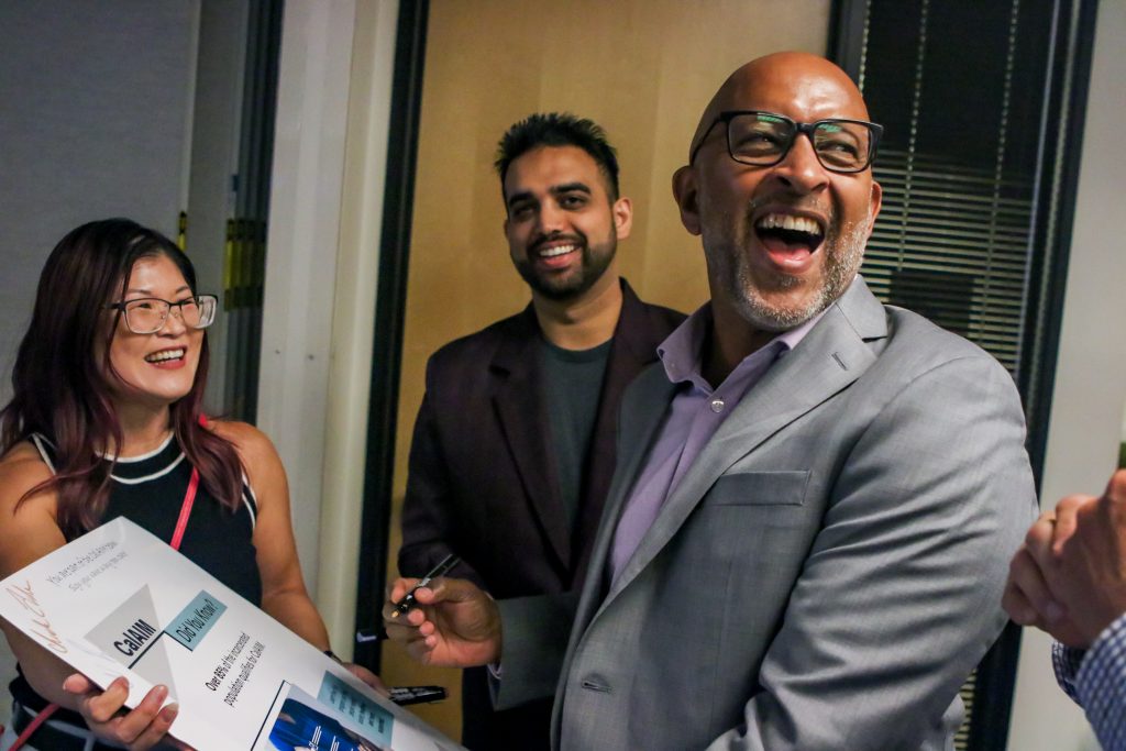Group of 3 staff laughing together at Elk Grove HQ CNE Conference