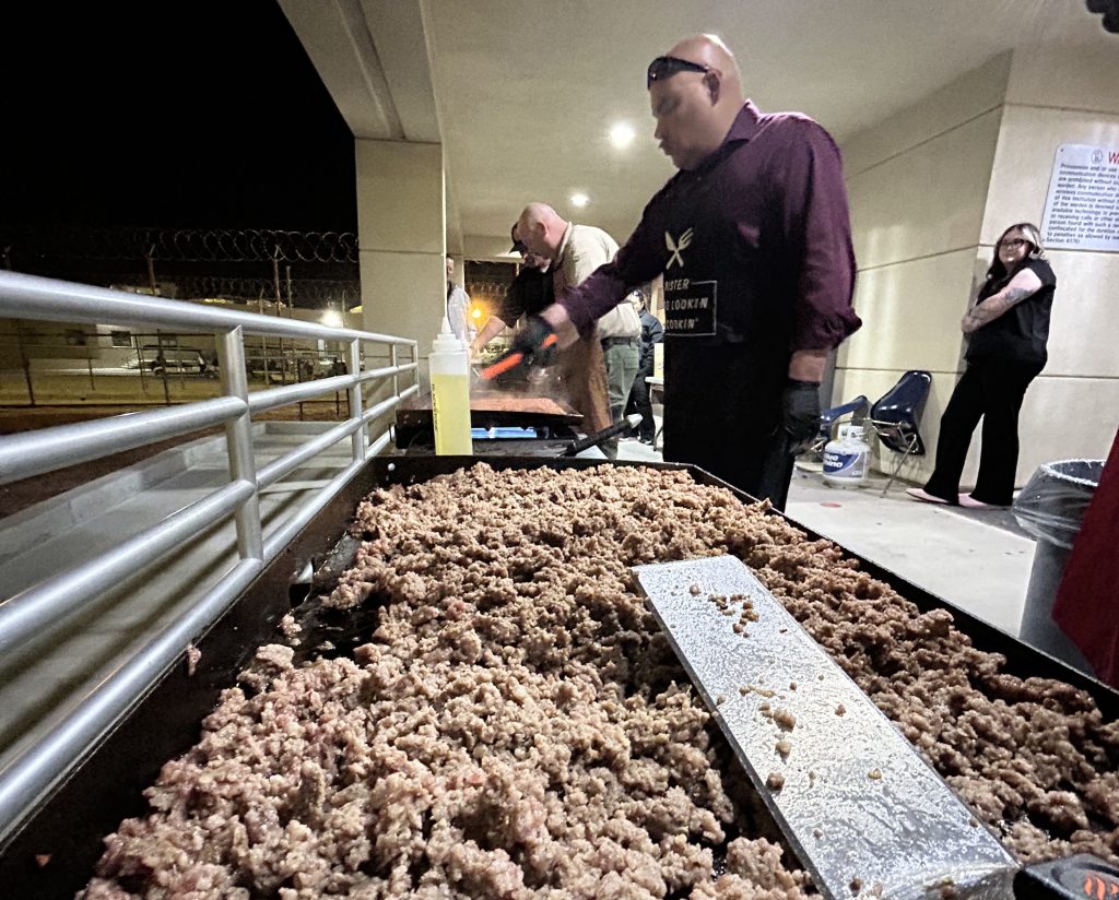 Managers and staff cook 300 pounds of meat for breakfast burritos for staff as they get off first watch at CSP-Los Angeles County.